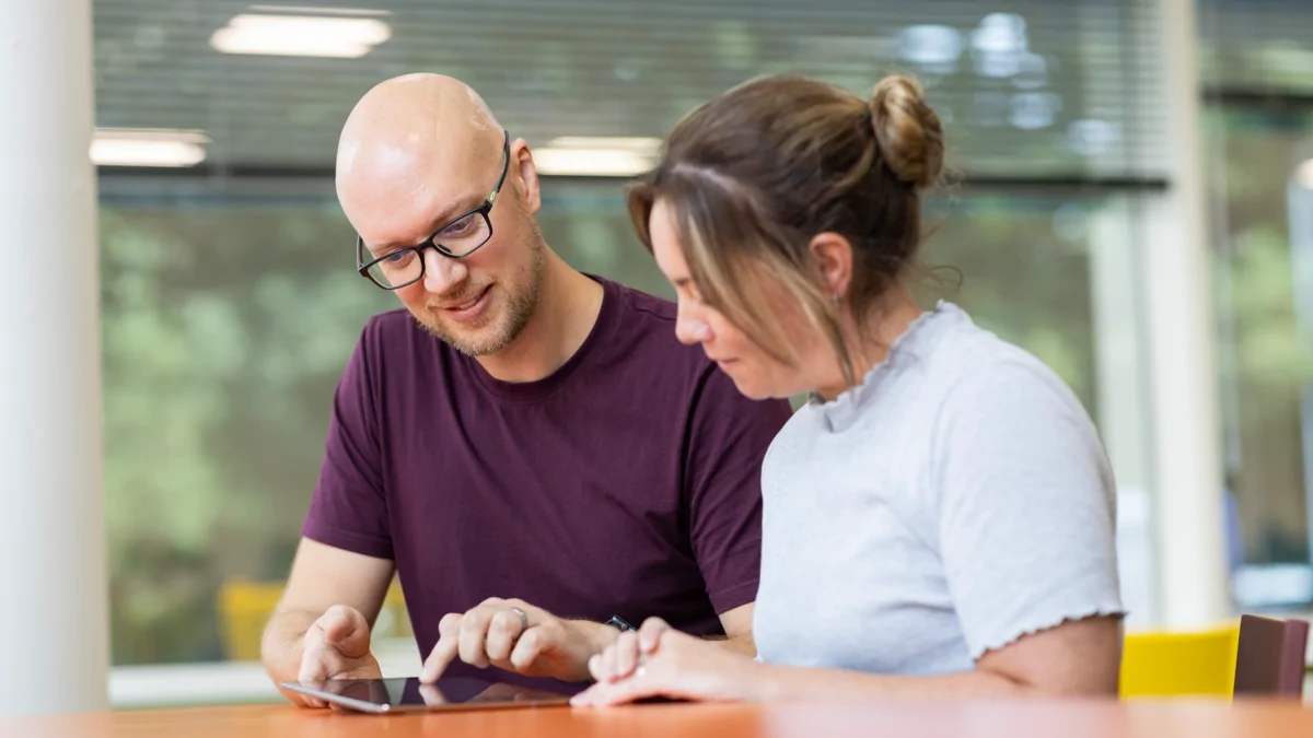 Image shows Moat colleagues looking at myMoat on tablet