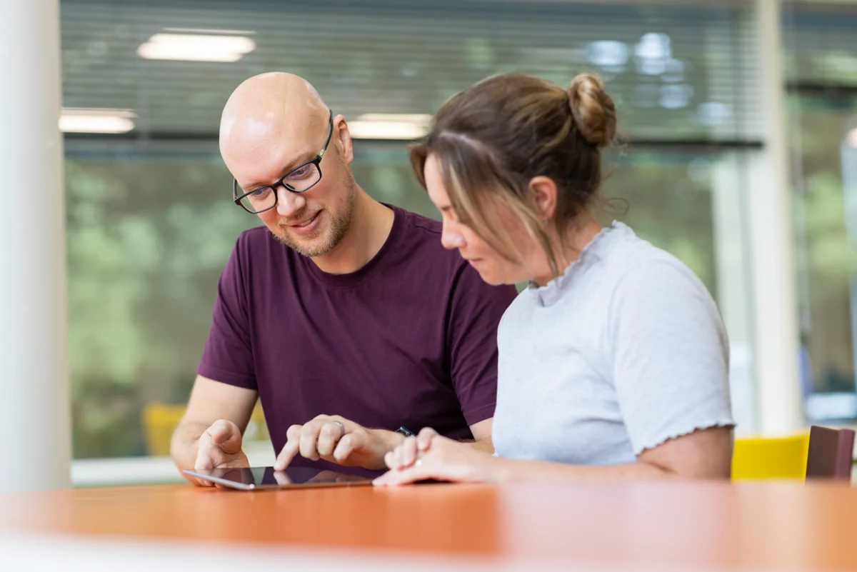 Image shows Moat colleagues looking at myMoat on tablet