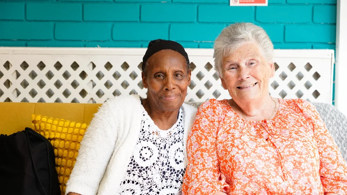 Two women sat on a sofa at the Wellbeing Studio in Pollards Hill