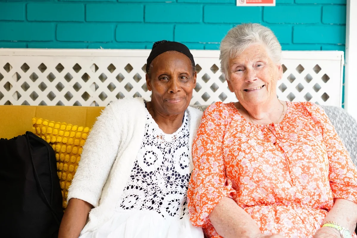 Two women sat on a sofa at the Wellbeing Studio in Pollards Hill