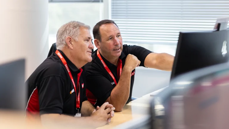 Mears colleagues sat at desk looking at computer screen