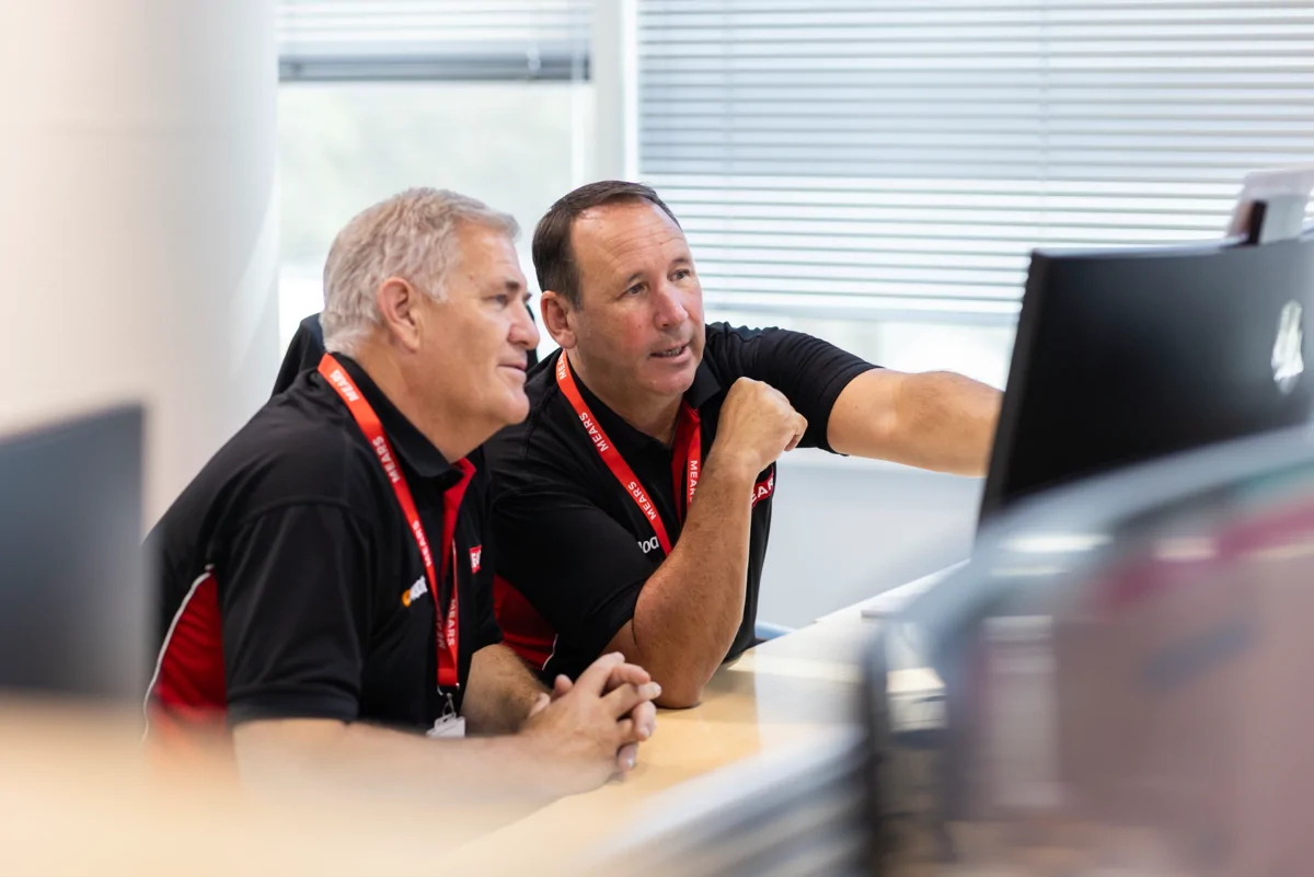 Mears colleagues sat at desk looking at computer screen