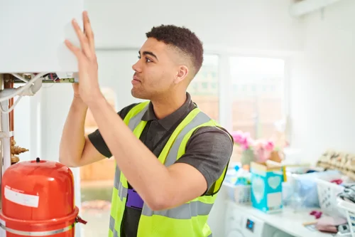 Maintenance operative fixes boiler