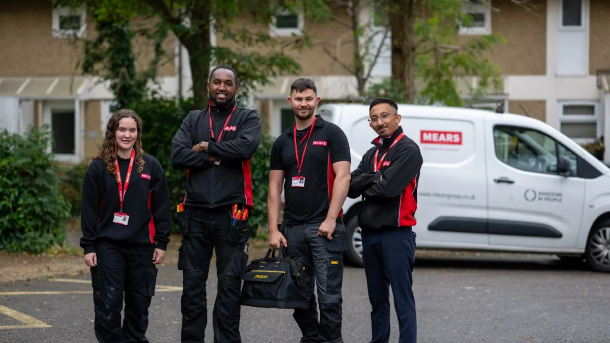 Image of four Moat operatives standing outside by a van